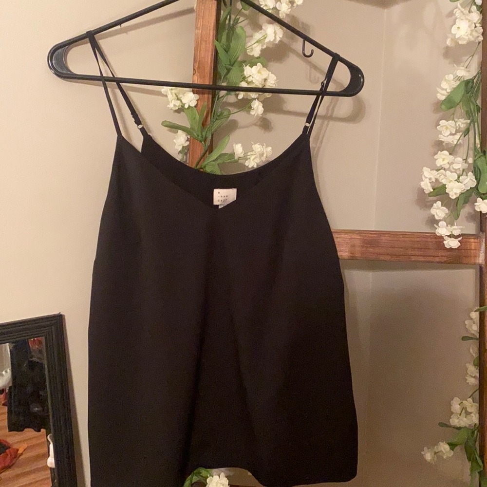 This is a women’s black strapped tank top from target! Size women’s medium